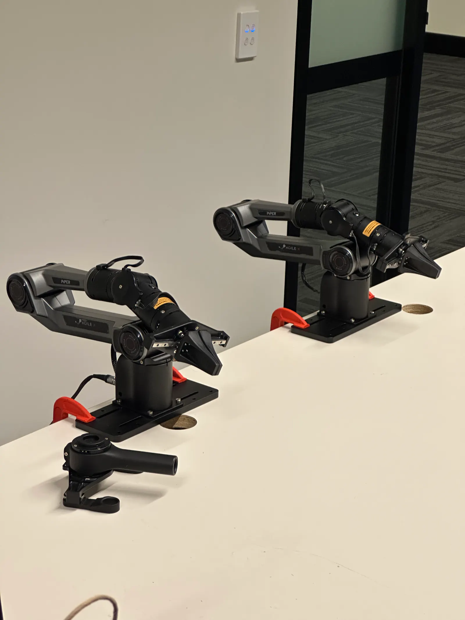 Two robotic arms in a StellarEdge AI workspace